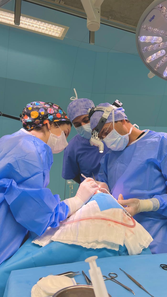 Mastering the First Impression: Your intriguing post title goes here Team of surgeons in blue scrubs performing surgery in a well-lit operating room.