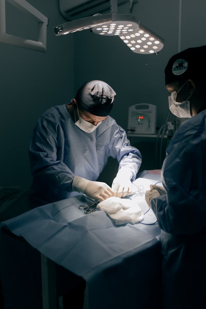 Surgeons in a sterile operating room performing a surgical procedure, showcasing teamwork and precision.