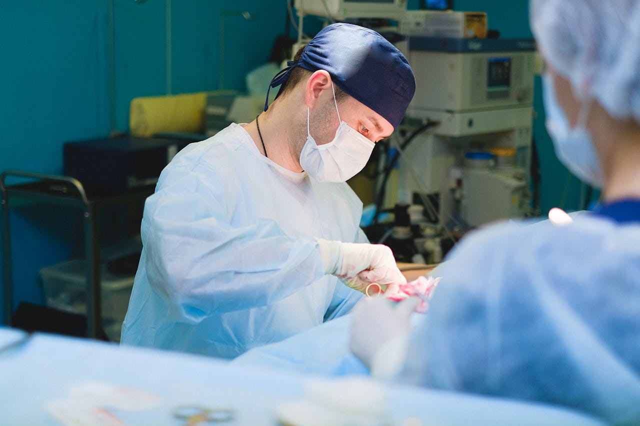 A team of surgeons performs a delicate procedure in a sterile hospital operating room.
